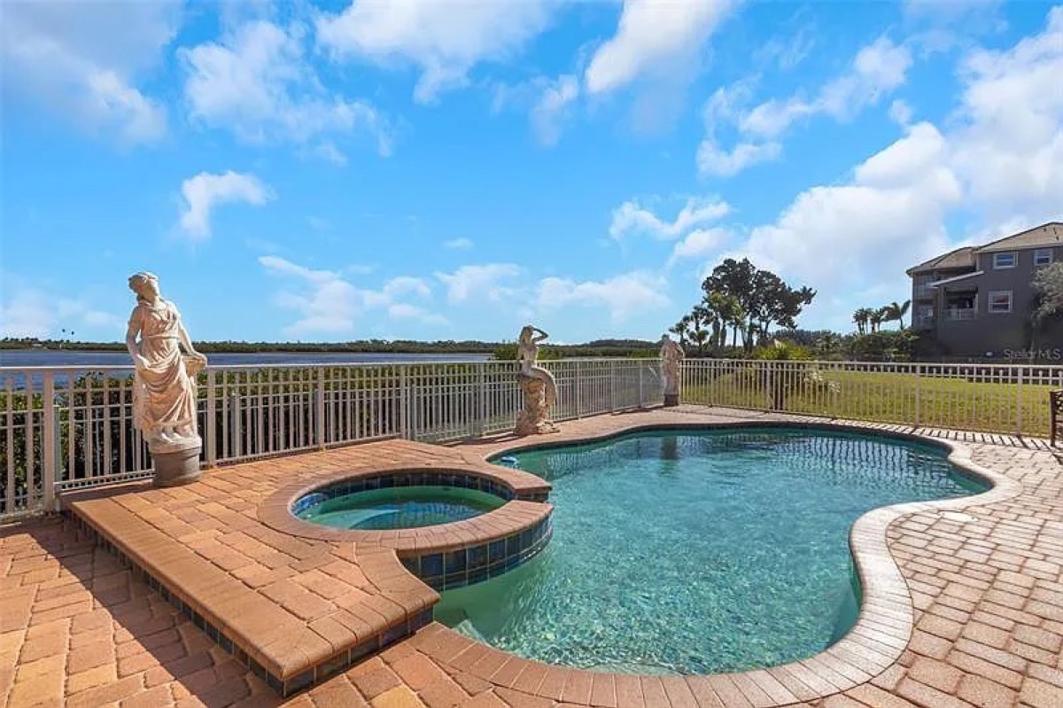 Sealed brick pavers around a lakefront pool